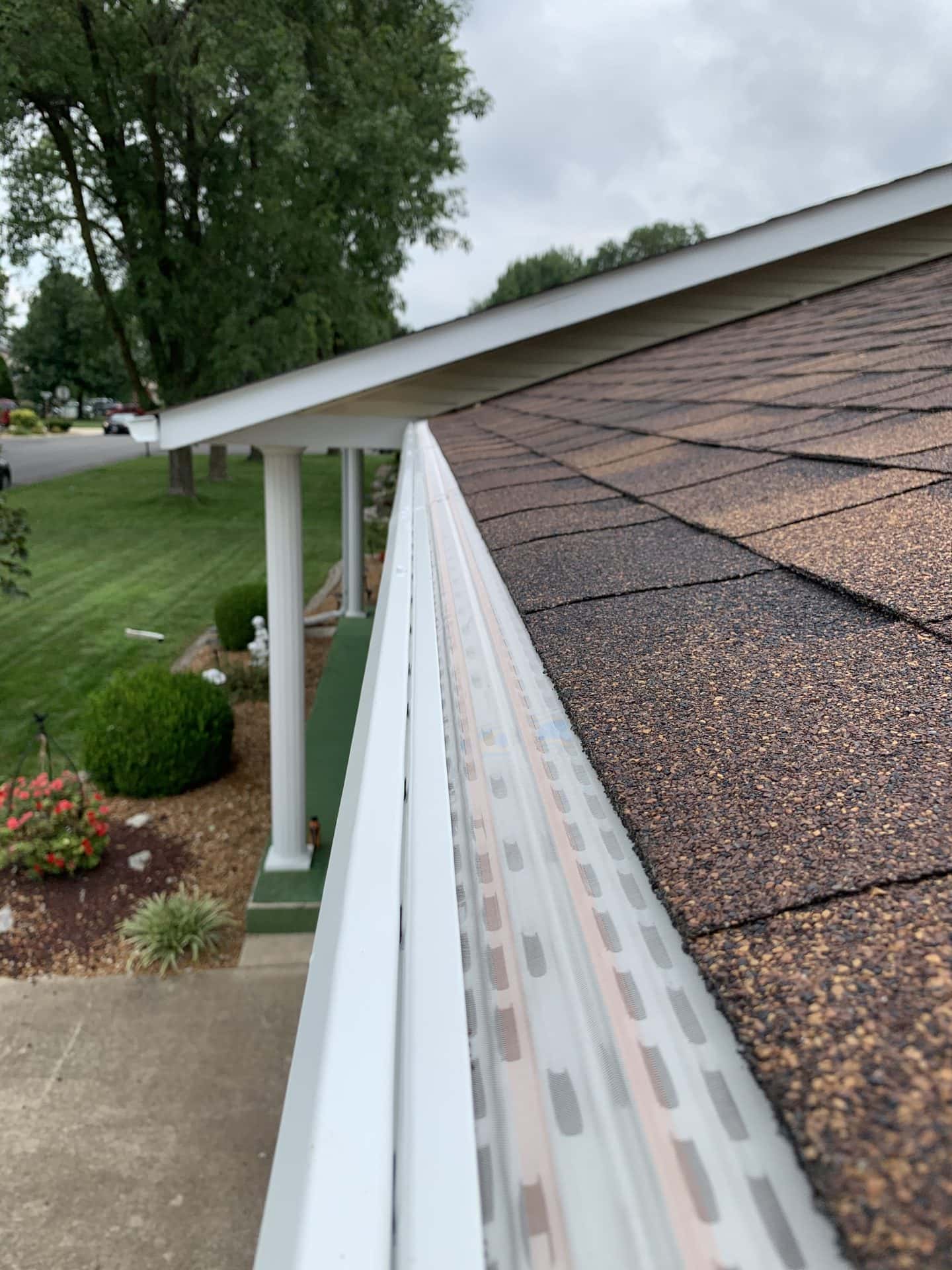 Lengthwise Close Up Of Gutter Guards On A Home With Shingle Roof